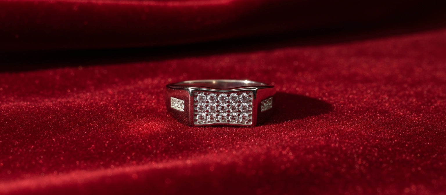 The Chairman's Pavé Ring by Narayan Jewellers, a 925 sterling silver statement ring with a multi-row pavé setting, on a luxurious red velvet background.