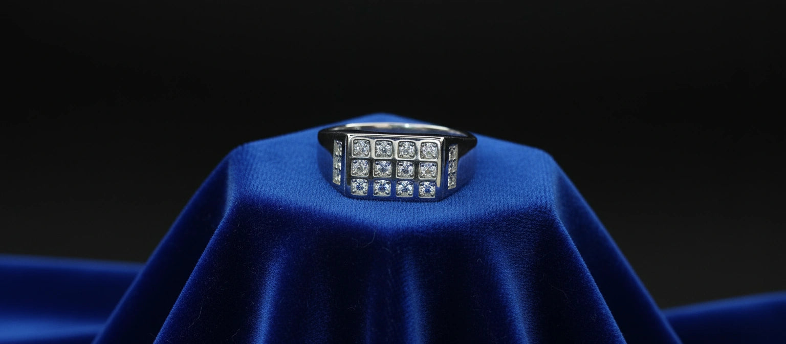 The Citadel Grid Ring by Narayan Jewellers, a 925 sterling silver statement ring with a multi-stone grid setting, on a royal blue velvet cushion.