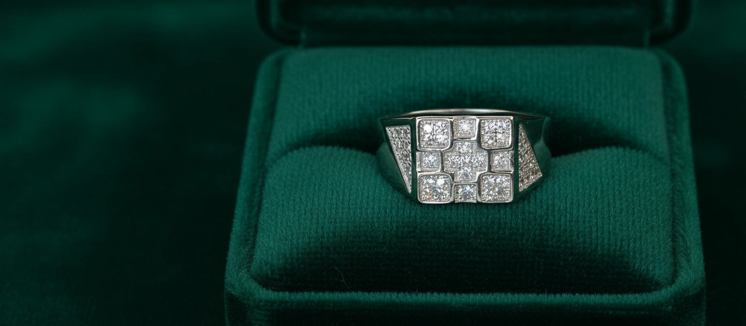 The Empire Pavé Ring by Narayan Jewellers, a 925 silver ring with a square mosaic of princess-cut stones, inside a green velvet ring box.